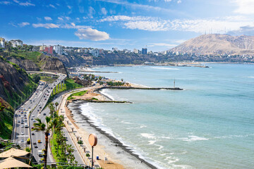 Fototapeta na wymiar View of Costa Verde Miraflores from the Pacific Ocean. In the background, Redondo Beach. Blue sky, green ocean and sunny day in 2023.
