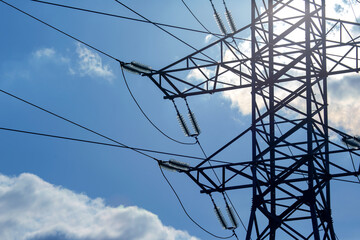 High voltage tower with electrical voltage wires isolates close-up against the background of...