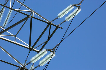 High voltage tower with electrical voltage wires isolates close-up against the background of...