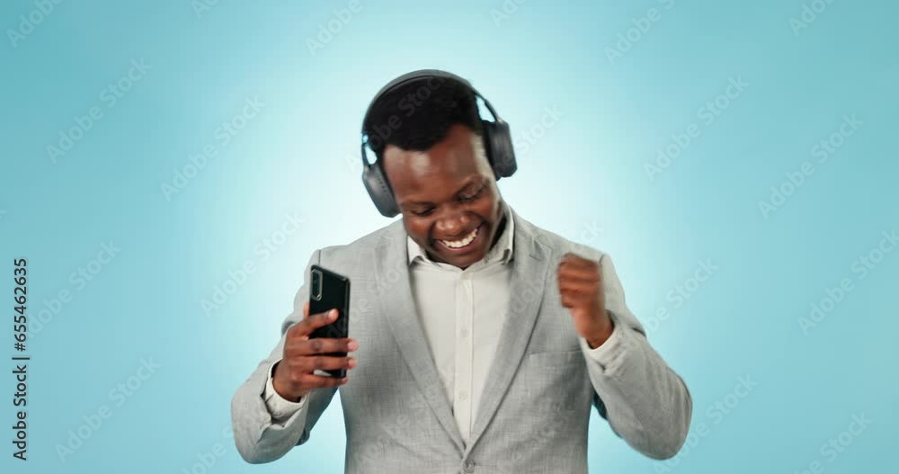 Poster Business man, headphones and dance in studio with phone for celebration, freedom and winning on blue background. Happy african worker listening to mobile music, audio and streaming radio with energy