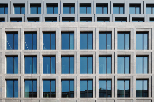 Outdoor exterior front view of modern facade with typical rectangular open and close windows.