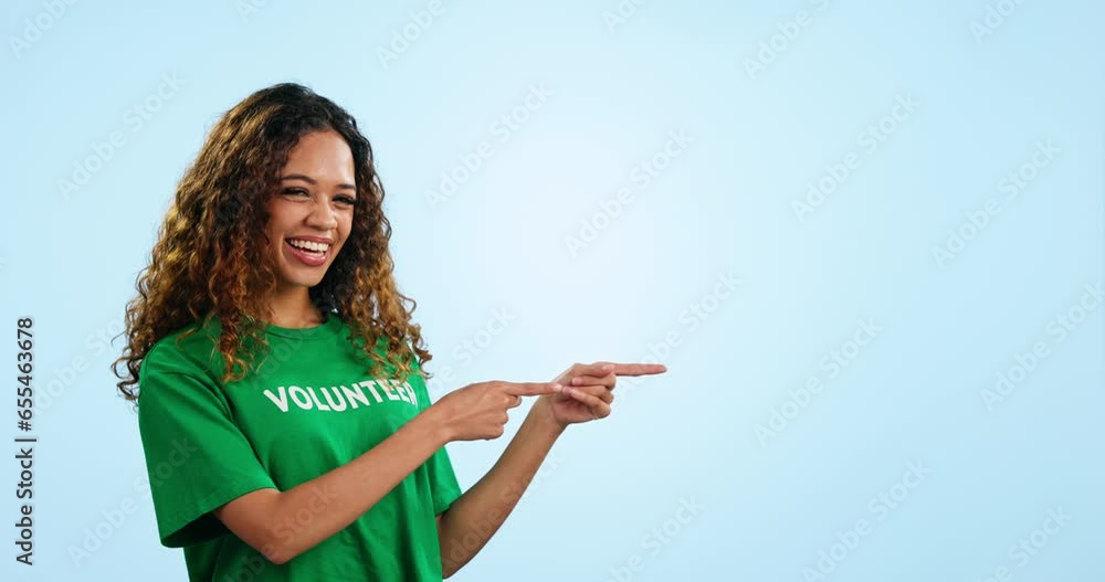 Wall mural Face, woman and volunteer with opportunity, pointing and promotion on a blue studio background. Portrait, presentation or charity worker with feedback, announcement or review with decision or choice