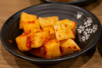 Closeup of Plate of Spicy Korean Radish Kimchi Served as Appetizer