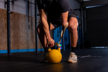 Unrecognizable disabled man exercising with a kettlebell
