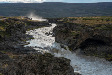 Obraz premium Godafoss waterfall and Skjalfandafljot River in northern Iceland under sunny autumn cloudscape.