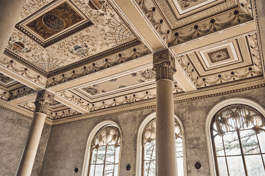  Abandoned soviet spa resort (sanatorium) Shakhter (Miner), in Tskaltubo, Georgia. Luxurious ancient hall with columns, painted ceiling, arched windows. Stalin Empire style - Powered by Adobe