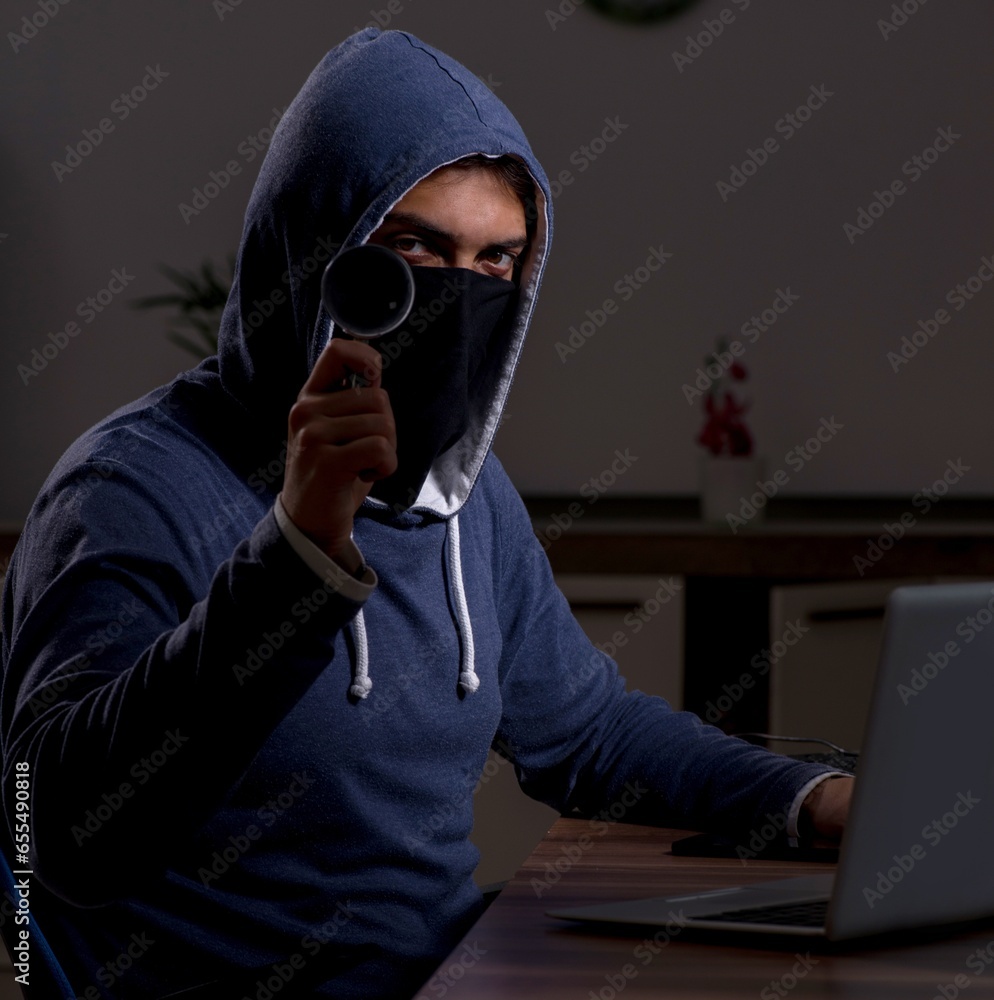 Poster male hacker hacking security firewall late in office