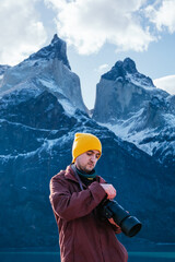 Vertical shot of a young male photographer in Torres del Paine National Park, Magallanes region, Chile