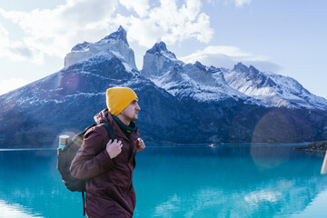 Vertical shot of a young male hiker in Torres del Paine National Park, Magallanes region, Chile