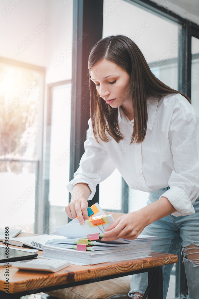 Poster businesswoman working in stacks of paper files for searching and checking unfinished document achiev