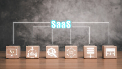 SaaS, software as a service concept, Wooden block on desk with software as a service icon on...