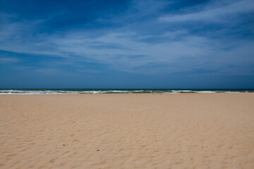 View of the sand, ocean and sky on Imbassaí beach, Bahia