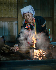 Karen women cook delicious local food in the kitchen at Karen Hill tribe Village at Doi Inthanon...