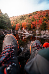 vertical photo of trekking shoes in an autumn forest