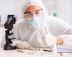 Young expert criminologist working in the lab