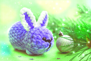 New Year decorations. Golden lights. Christmas card with funny toy bunny. Happy new year