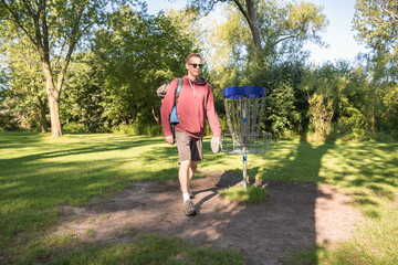 And on to the next hole: Disc golf is a flying disc sport in which players throw a disc at a...