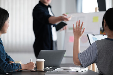 A professional and smart Asian businessman or male boss is working on a new project with his team in the meeting. brainstorming, discussion, teamwork, startup company