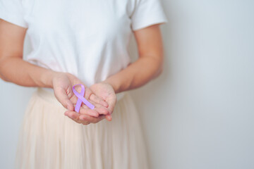 woman holding Purple Ribbon for Stomach, Violence, Pancreatic, Esophageal, Testicular cancer,...