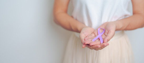 woman holding Purple Ribbon for Stomach, Violence, Pancreatic, Esophageal, Testicular cancer,...