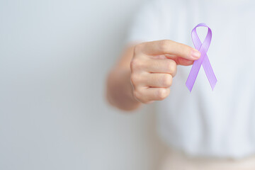 woman holding Purple Ribbon for Stomach, Violence, Pancreatic, Esophageal, Testicular cancer,...