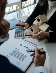 Real estate agent and customer signing contract to buy house, insurance or loan real estate.rent a house,get insurance or loan real estate or property.