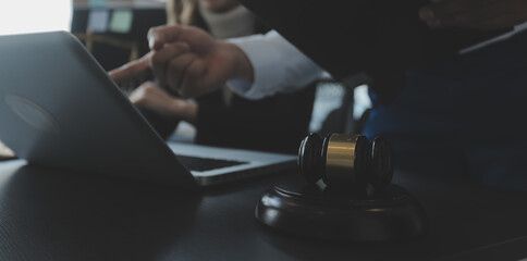 Male lawyer working with contract papers and wooden gavel on tabel in courtroom. justice and law ,attorney, court judge, concept.