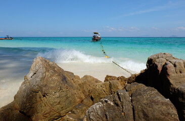 waves crashing on rocks
Fishing boat resting at sea on quiet tourist island