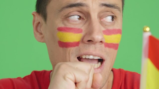 Very nervous man supporting spanish team during a difficult match.