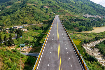 Top aerial view of the Mong Sen Bridge on 4D national road from Sapa town to Lao Cai city, Vietnam. © Dong