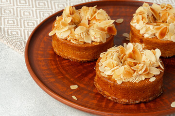 Obraz na płótnie Canvas Tart pie with almond petals on plate