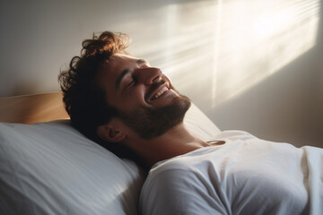 A man happily wakes up in white bedroom