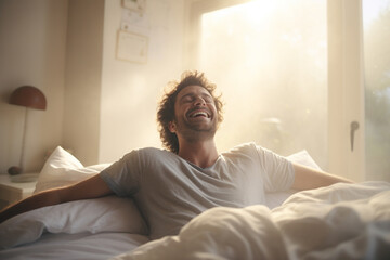 A man happily wakes up in white bedroom - obrazy, fototapety, plakaty