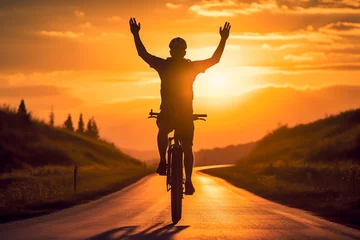 Tuinposter a man riding a bicycle on a road at sunset © toonsteb