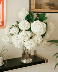 White hydrangea bouquet adorns the living room shelf