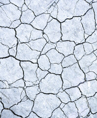 Overhead view of gray colored dry cracked earth.