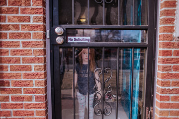 Upset toddler standing inside house