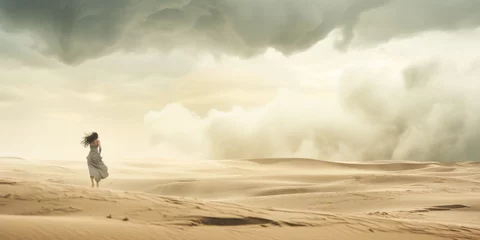 Fotobehang Dramatic solitary woman braving a sandstorm in desert. © XaMaps