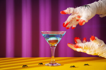 Hands wrapped in a bandage with a cocktail