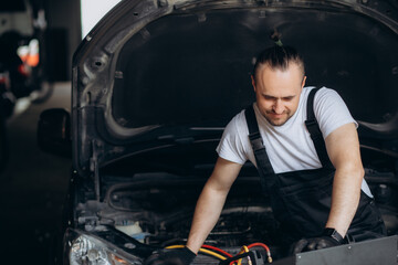 Mechanic connects air conditioning system