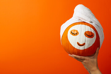 Skin and face care concept - pumpkin beauty mask
