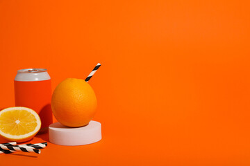 Tin cans and oranges on orange background, space for text
