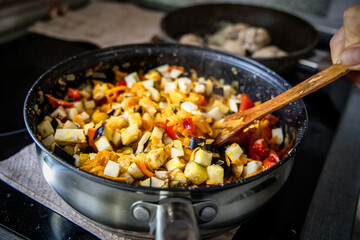 culinary masterpiece in the making: ratatouille being cooked by a talented chef.