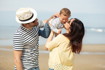 family fun with young infant on the beach