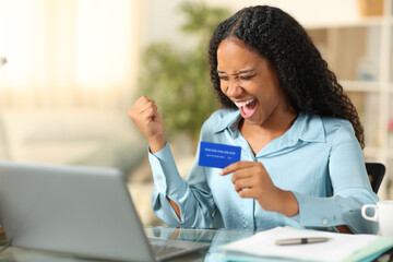 Excited black tele worker buying online