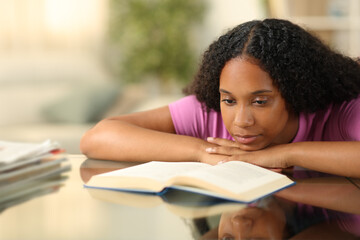 Serious black woman reading a paper book