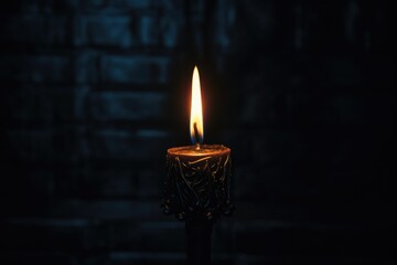 Fototapeta premium a dark shot focused on the flame of the black candle in the middle