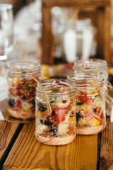 Salad of tomatoes, cucumbers and paprika. The salad is beautifully presented in a glass bowl