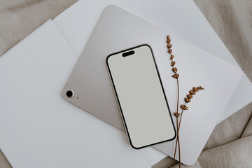Cell phone, tablet, neutral tan beige cloth, dried grass. Aesthetic mock up with empty free copy...