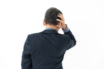 頭を抱えるビジネスマンの後姿